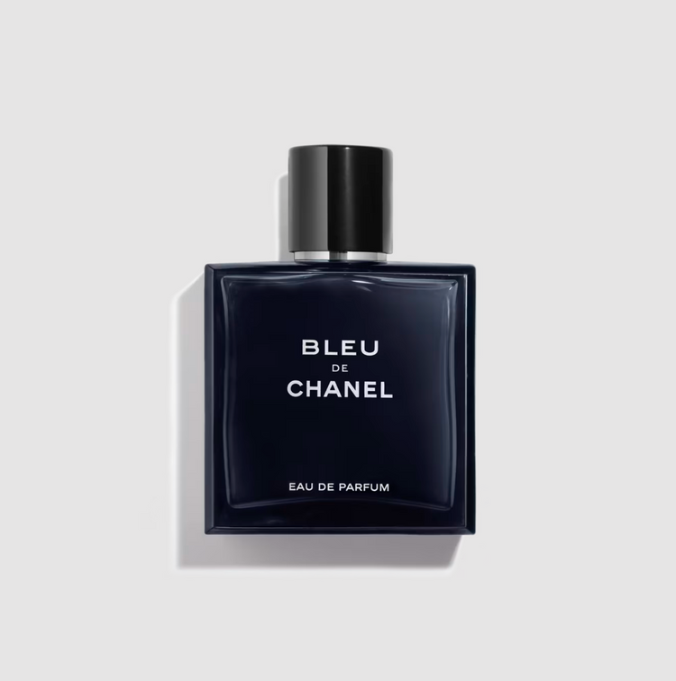 Sleek navy bottle with black cap, minimalist white text against clean background.