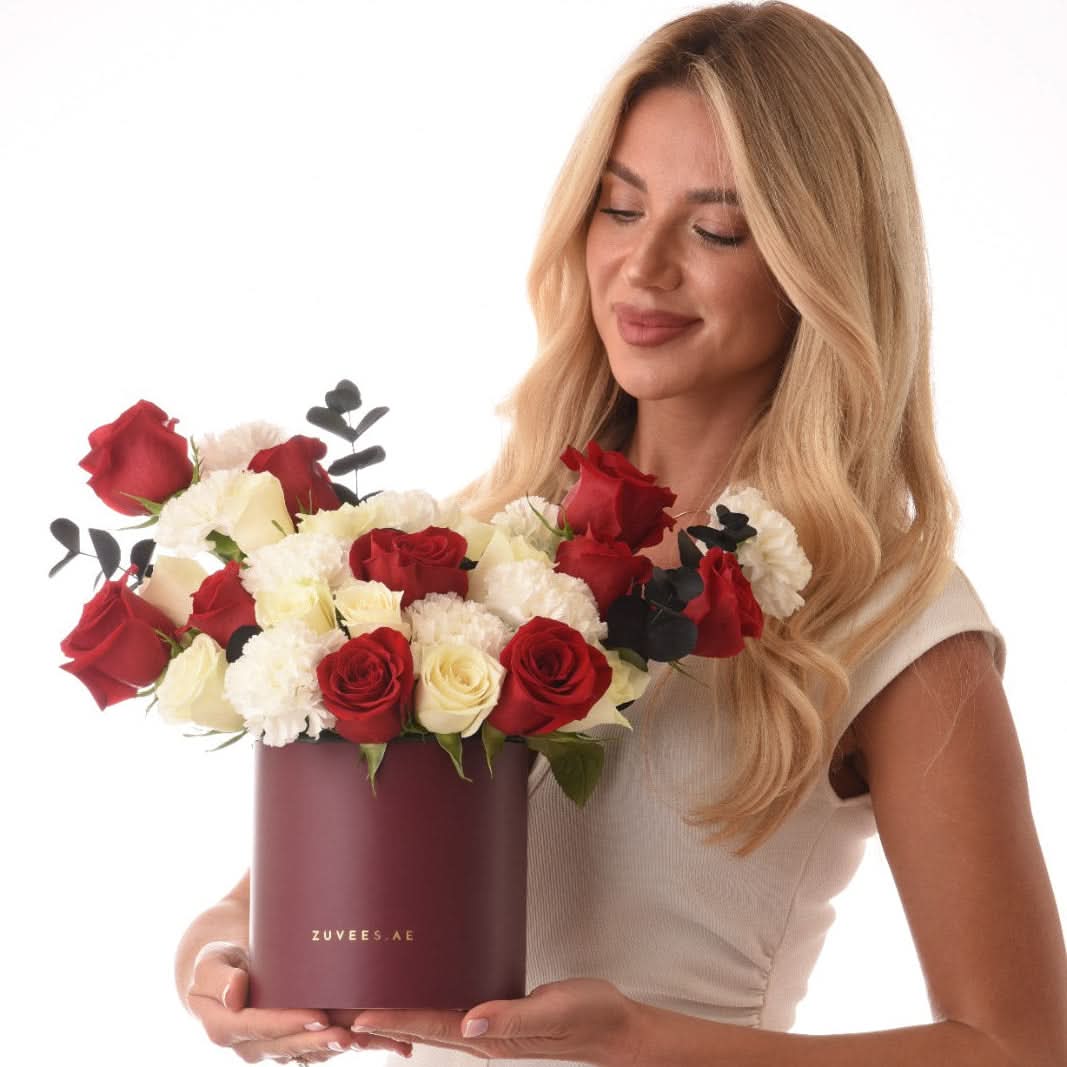 Elegant black box with red and white roses from, paired with fine chocolates of Zuvees Luxe Chocolate, Mirzam and Lakrids — a refined romantic gift.