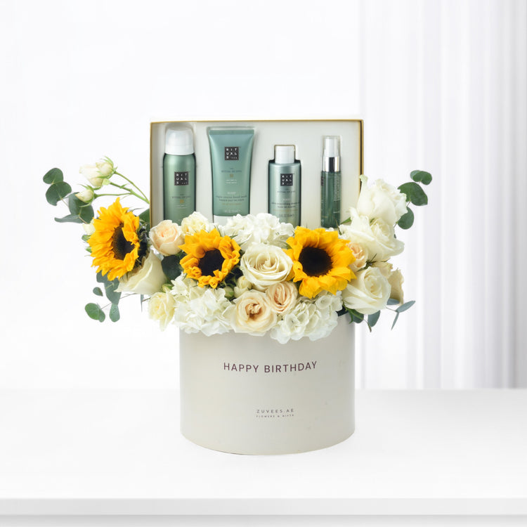 White box with "Happy Birthday," sunflowers, roses, and Rituals skincare set.