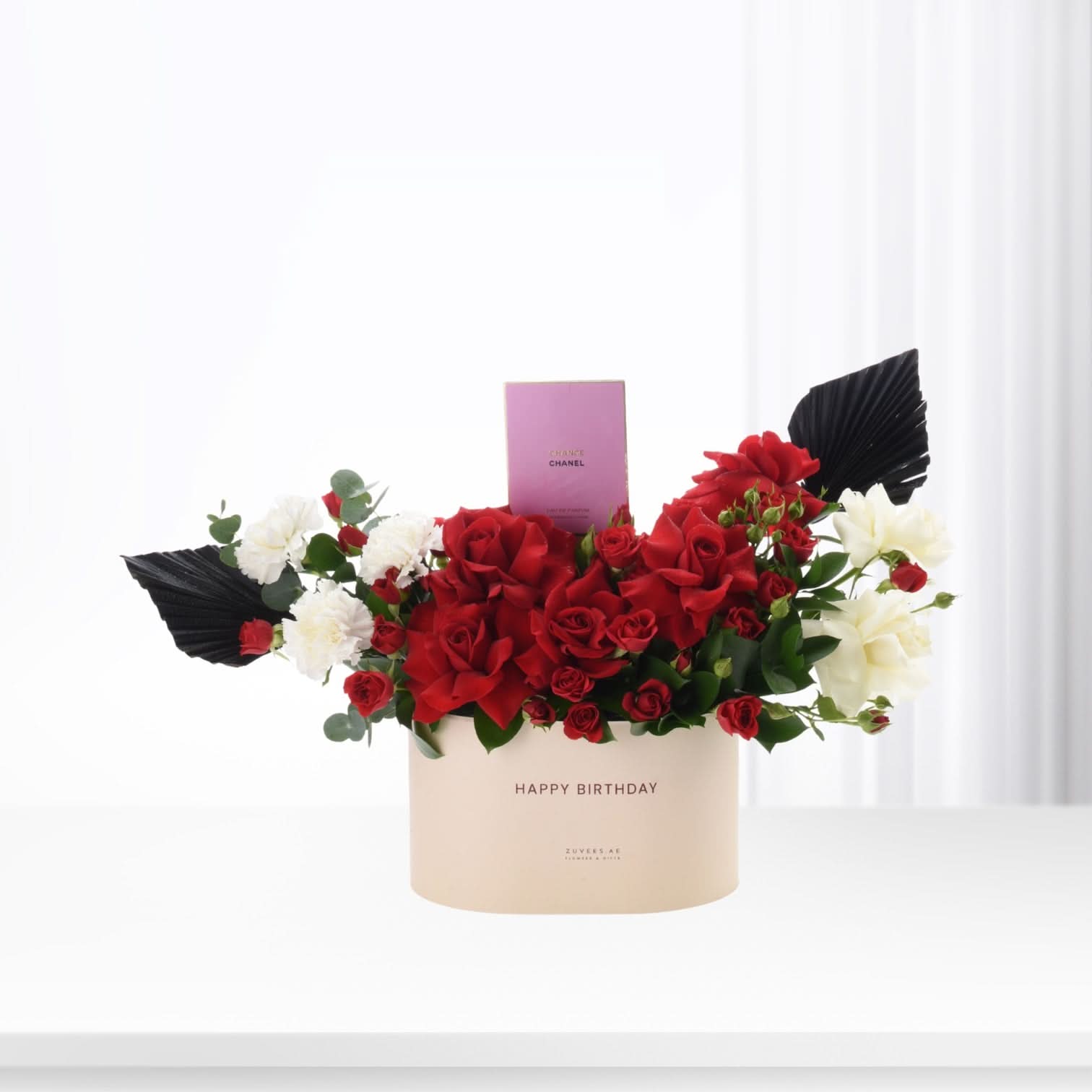 Red and white roses with black leaves in cream "Happy Birthday" box, Chanel perfume gift.