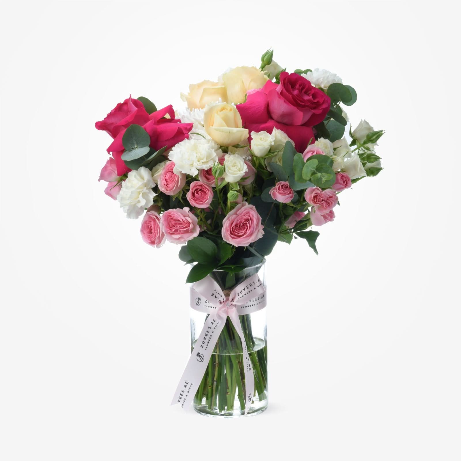 Vibrant pink, red, and white roses in clear vase with branded ribbon.