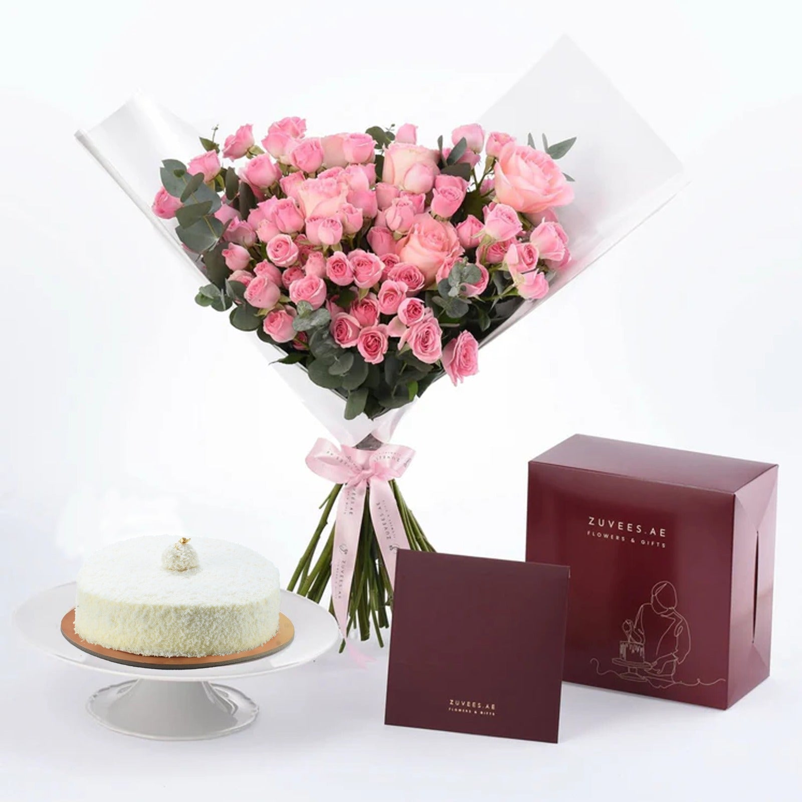 Pink roses bouquet with white cake and burgundy gift box.