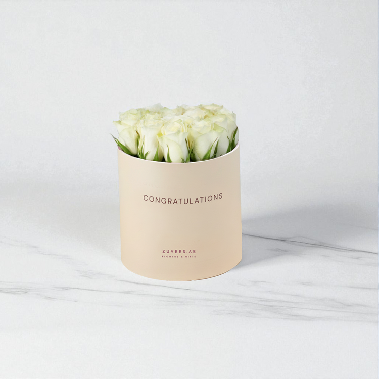 Cream box holds pristine white roses, "Congratulations" printed elegantly.