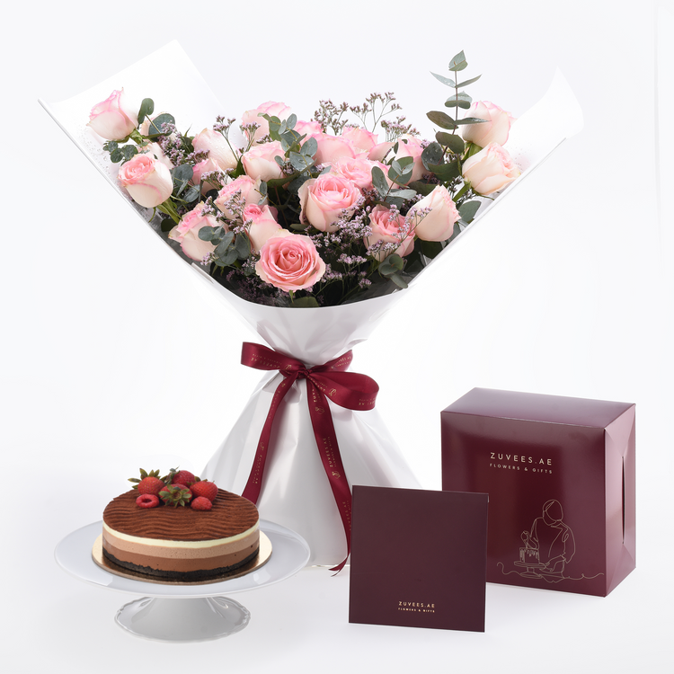 Pink roses bouquet with chocolate cake, burgundy ribbon, and elegant gift boxes.
