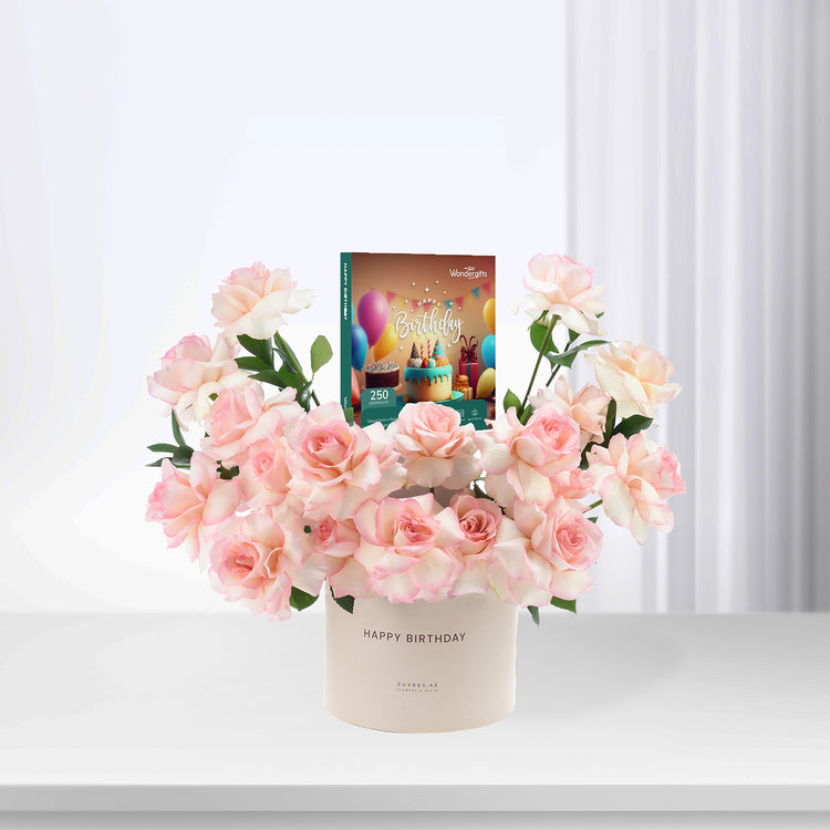 Soft pink roses in cream vase with "Happy Birthday" card, elegant gift arrangement.