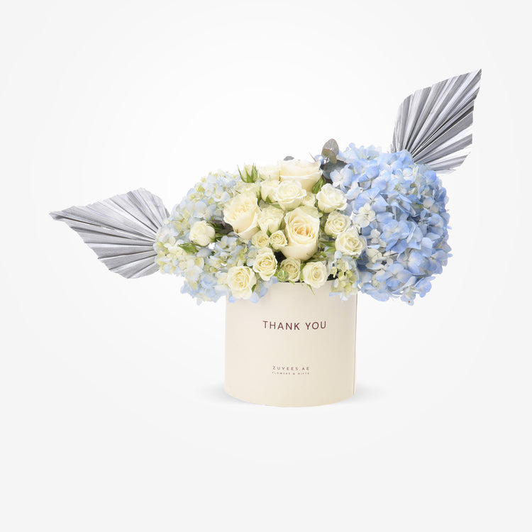 Elegant blue hydrangeas and cream roses in "Thank You" box with silver fan accents.