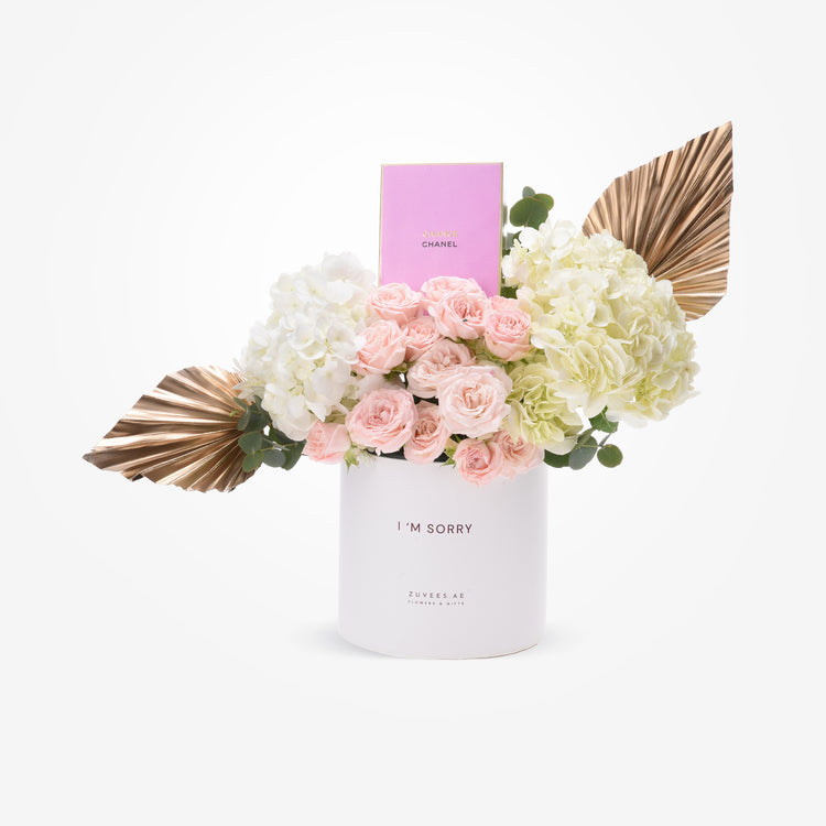White hydrangeas, blush roses, gold leaves in “I’m Sorry” box with Chanel perfume.