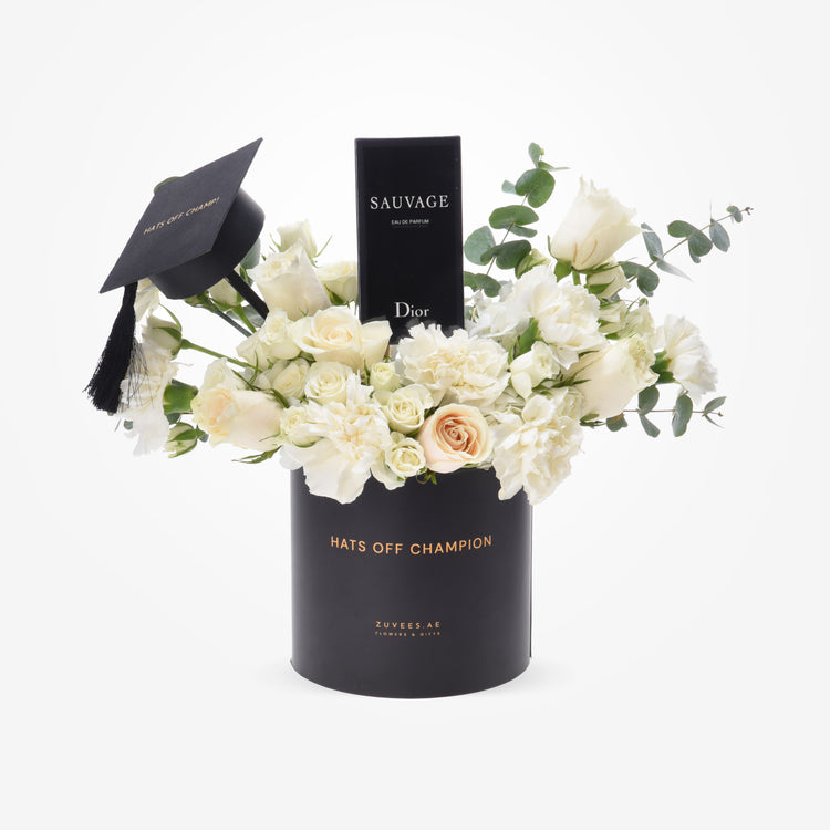 Elegant black graduation-themed floral gift with white roses, eucalyptus, and Dior perfume.