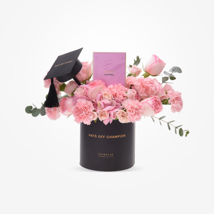 Pink roses and carnations in black graduation-themed vase with Chanel gift.