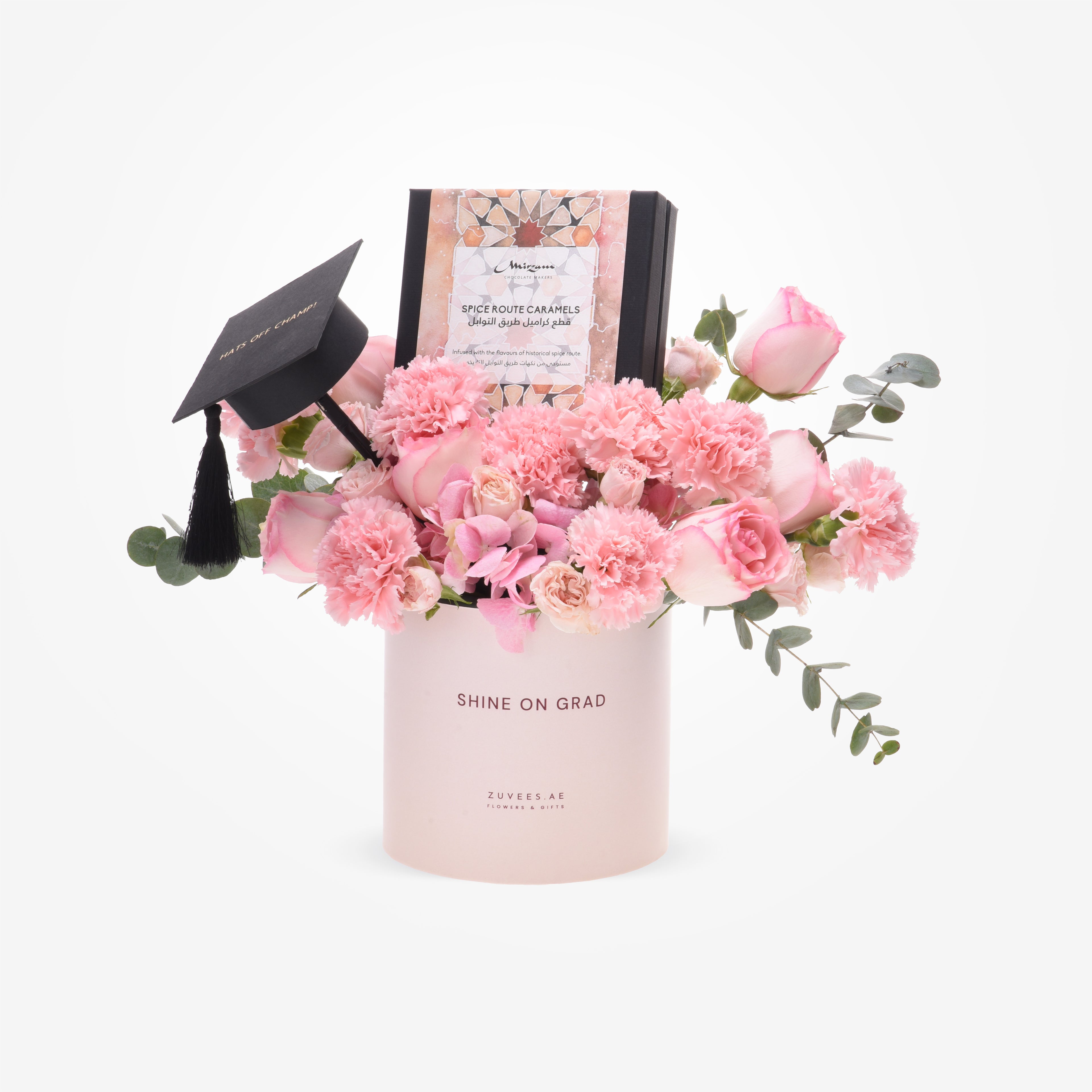Pink floral graduation gift with chocolate box and tiny cap.
