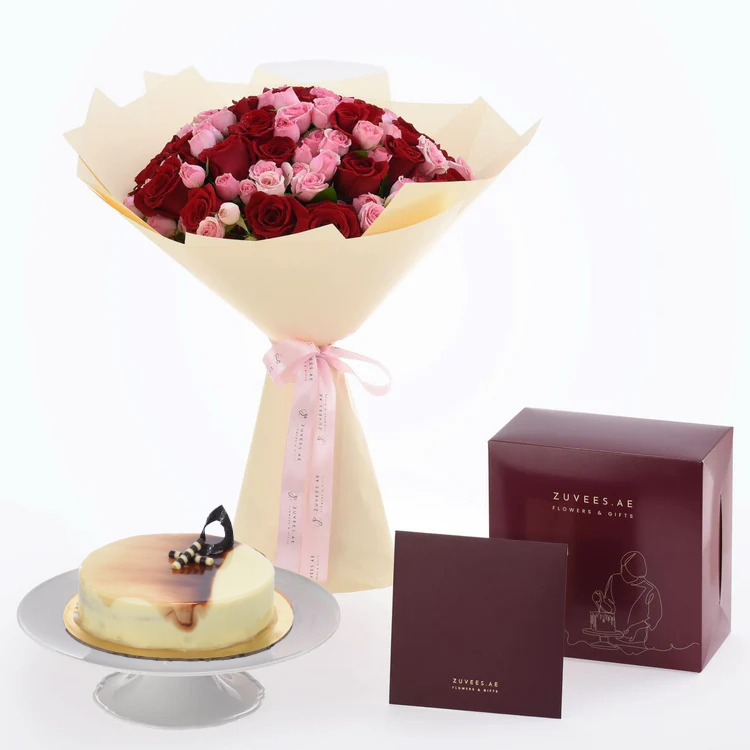 Luxurious red and pink roses bouquet paired with elegant cheesecake and branded gift box.