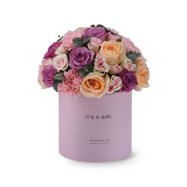 Soft pink and purple roses in lavender box reading "It&