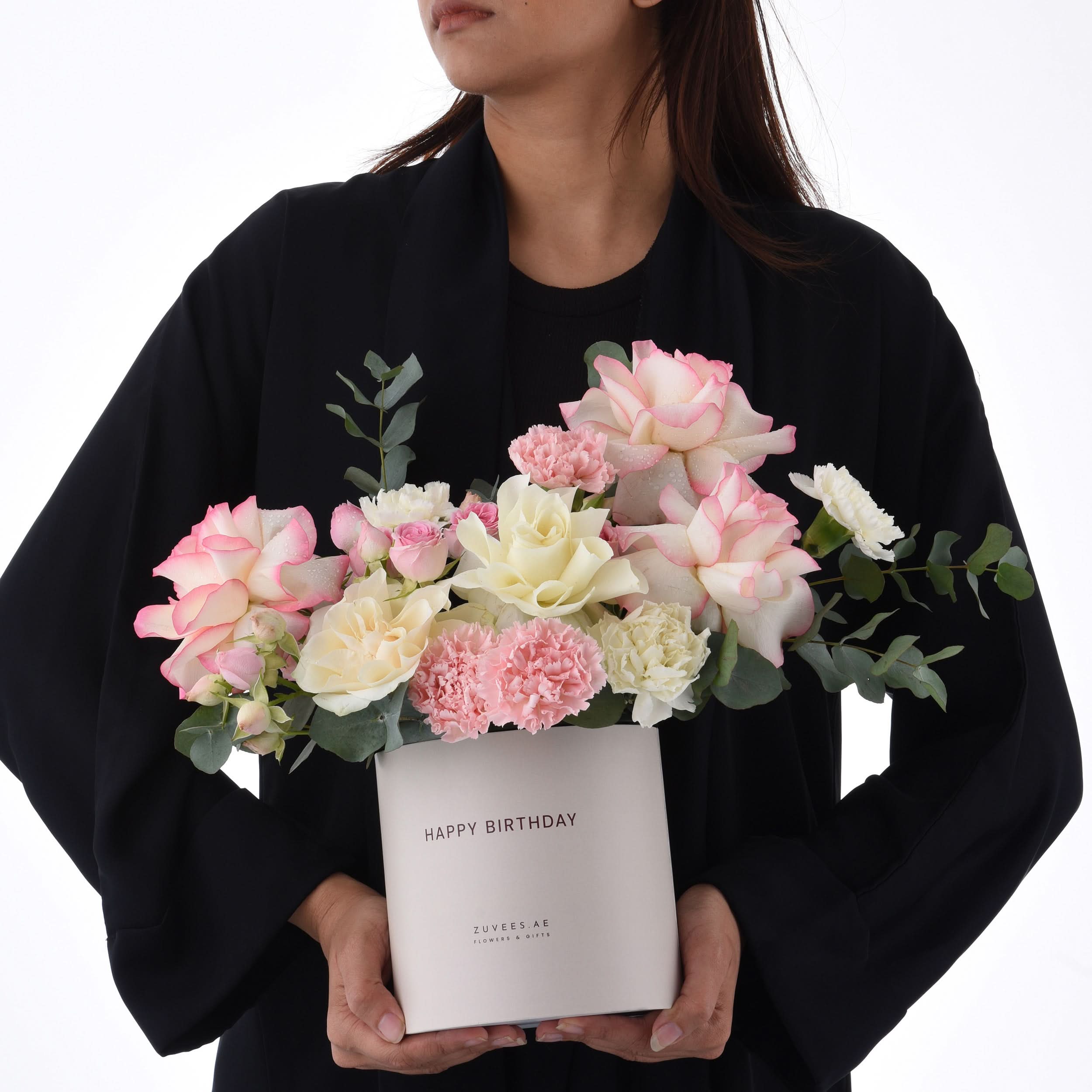 Elegant pink and white roses, carnations, and eucalyptus in a "Happy Birthday" box.