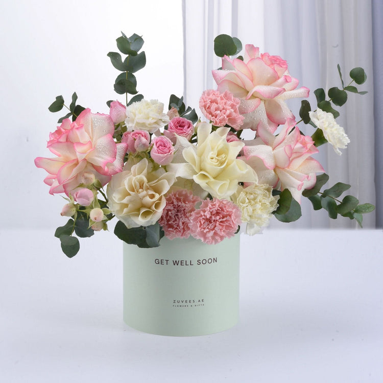 Pastel pink, white roses and carnations in mint-green "Get Well Soon" box.