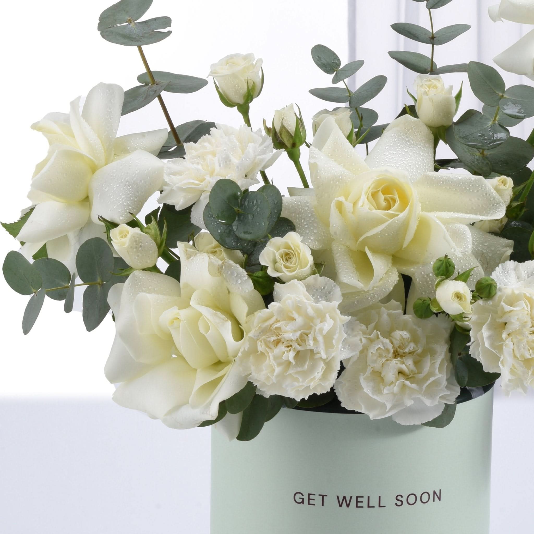 White roses and carnations with dewdrops in mint "Get Well Soon" vase.