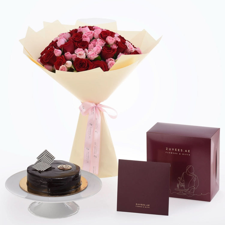 Rich red and pink roses in cream wrap, paired with chocolate cake and branded gift box.