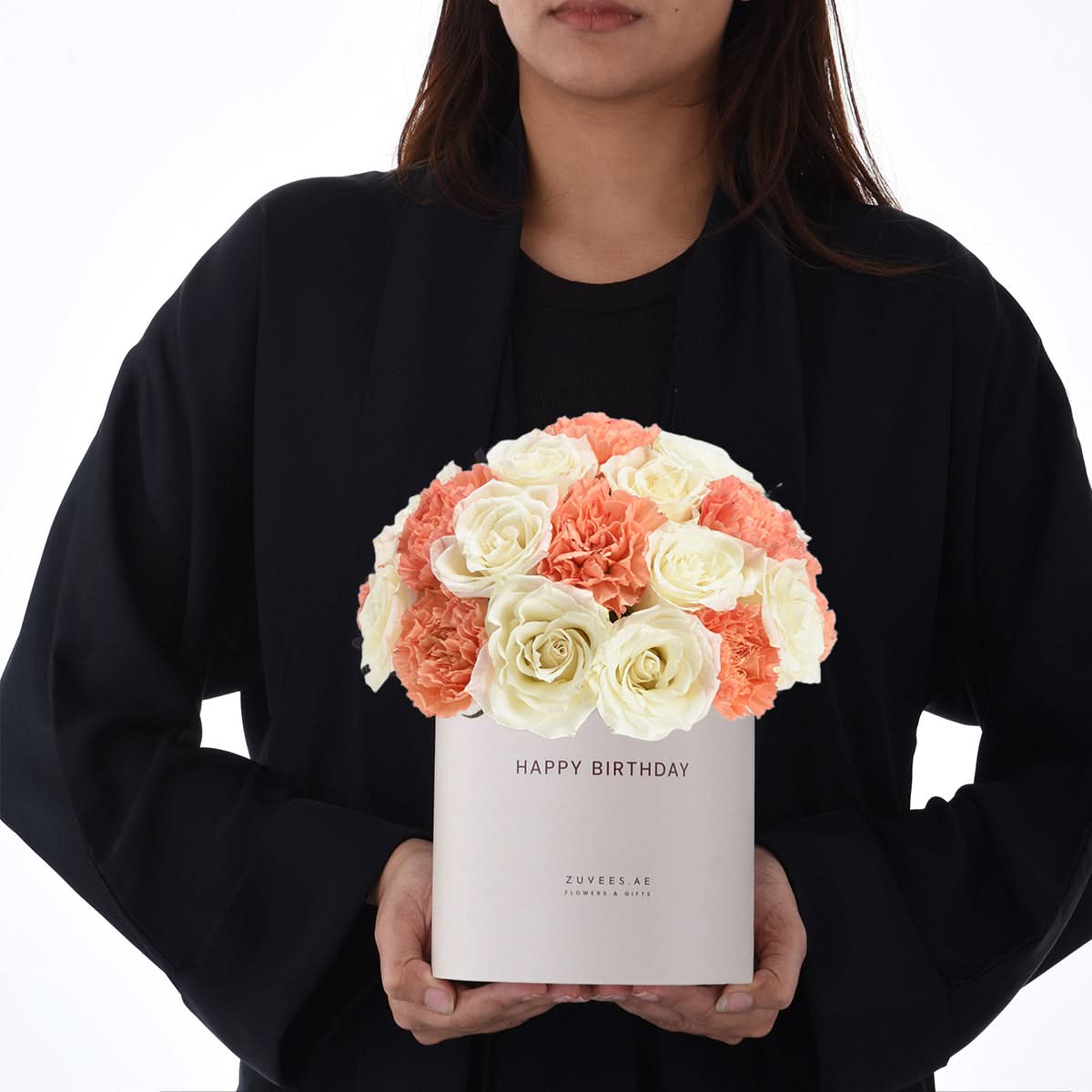 White box holds coral roses and carnations, “Happy Birthday” printed.