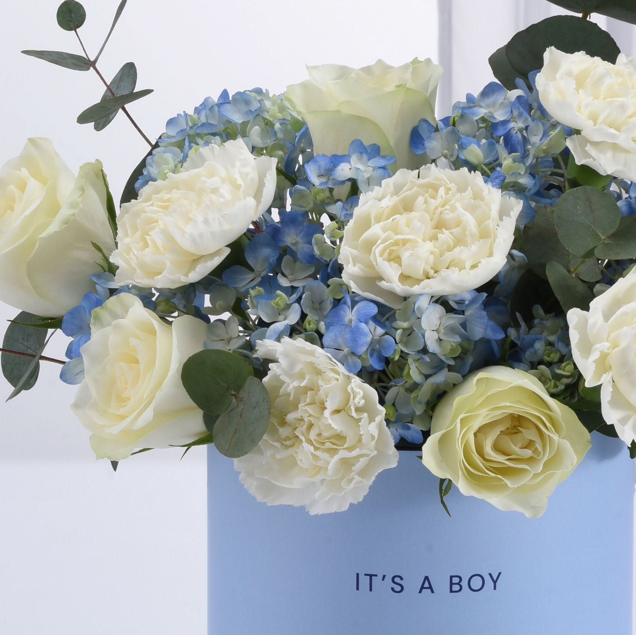 Elegant blue and white floral arrangement in "It&