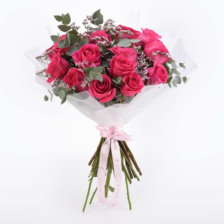 Vibrant pink roses, eucalyptus, and baby&