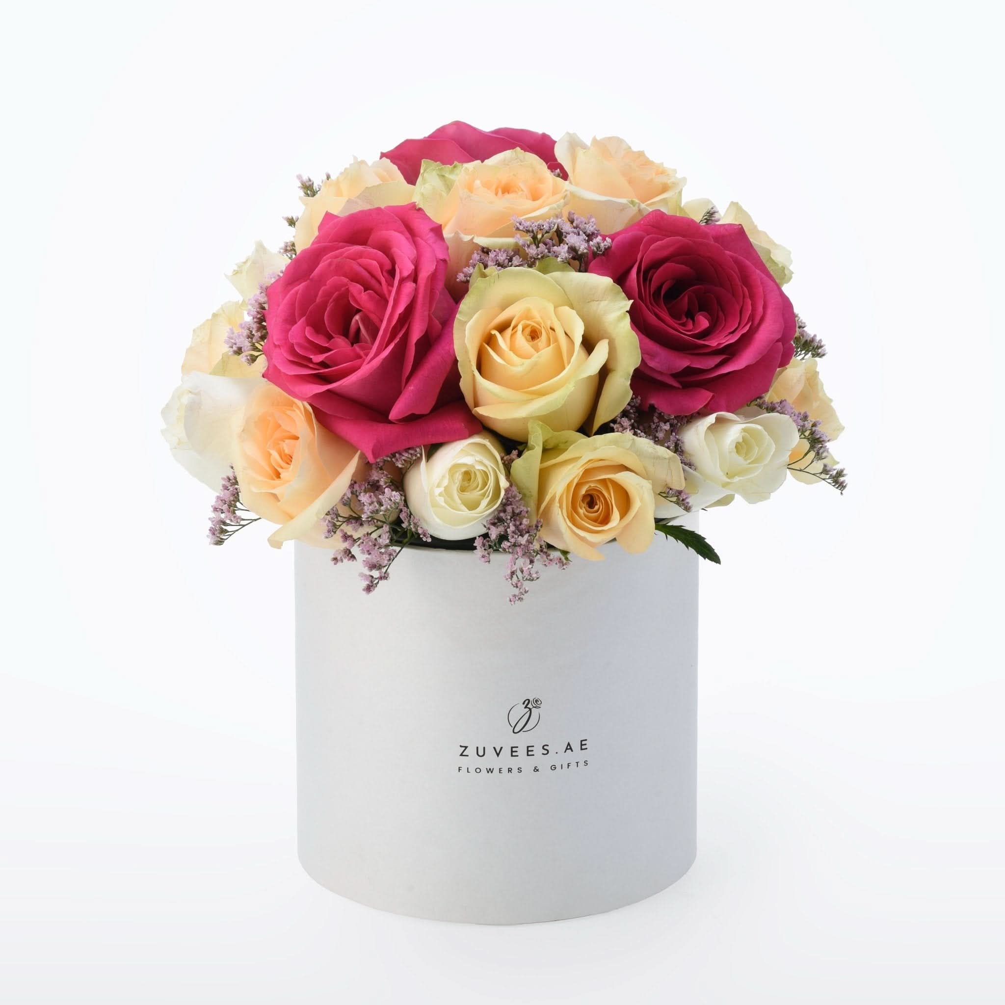 Vibrant pink, yellow, and white roses in elegant white box with ZUVEES.AE branding.