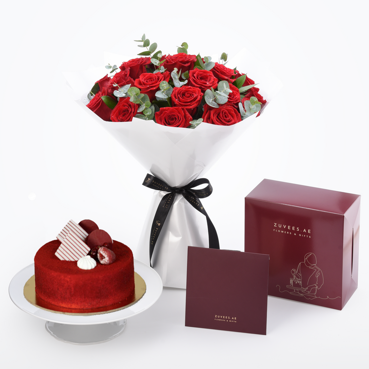 Vibrant red roses with eucalyptus, red velvet cake, and elegant burgundy gift boxes for romantic gifting.