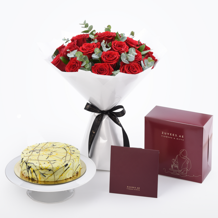 Vibrant red roses with eucalyptus, white chocolate cake, burgundy gift boxes, elegant black ribbon, Zuvees.AE branding.