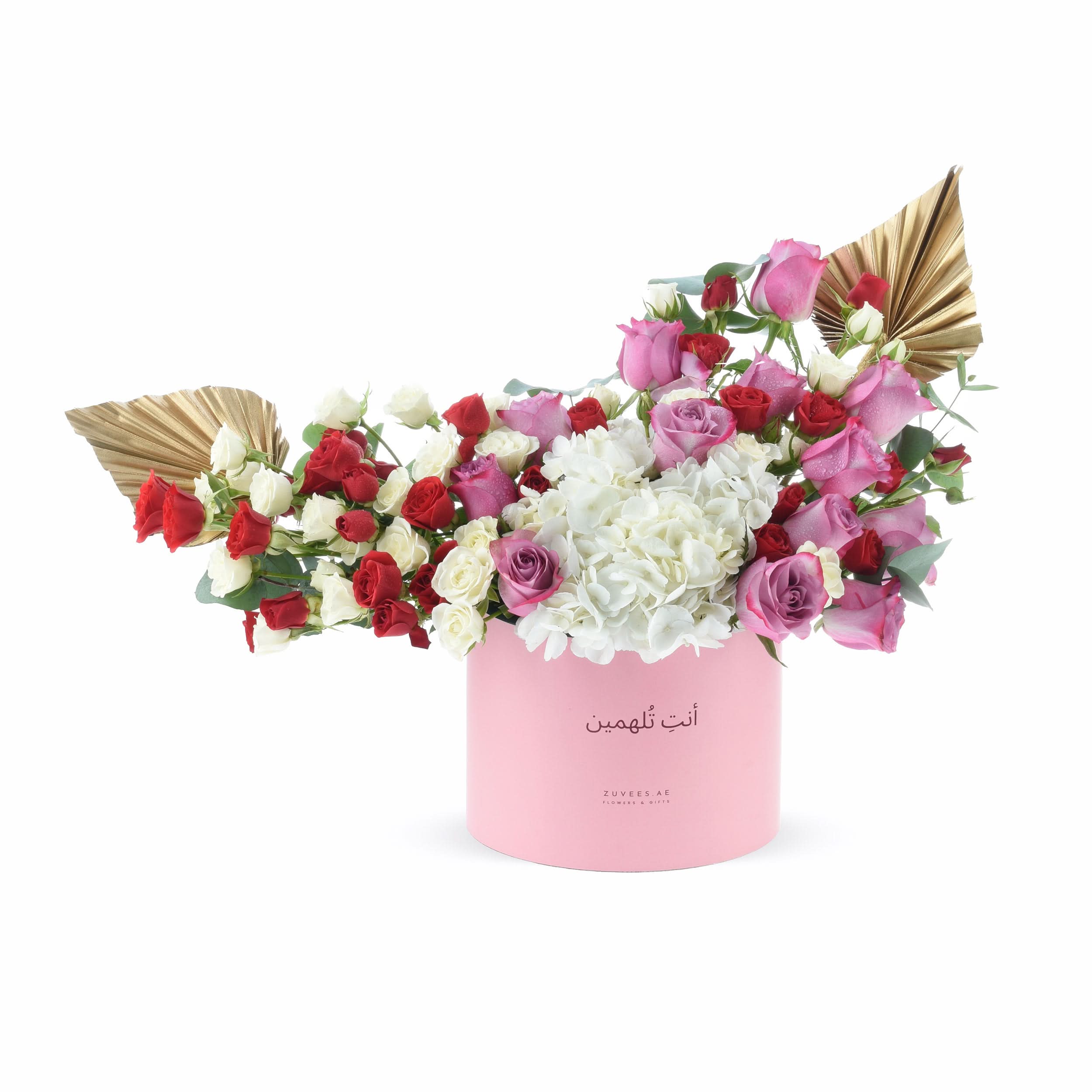 Pink box holds red, white, and pink roses with hydrangeas and gold fan accents.