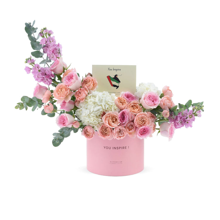Soft pink roses, hydrangeas, and eucalyptus in a pastel pink box with "You Inspire" card.