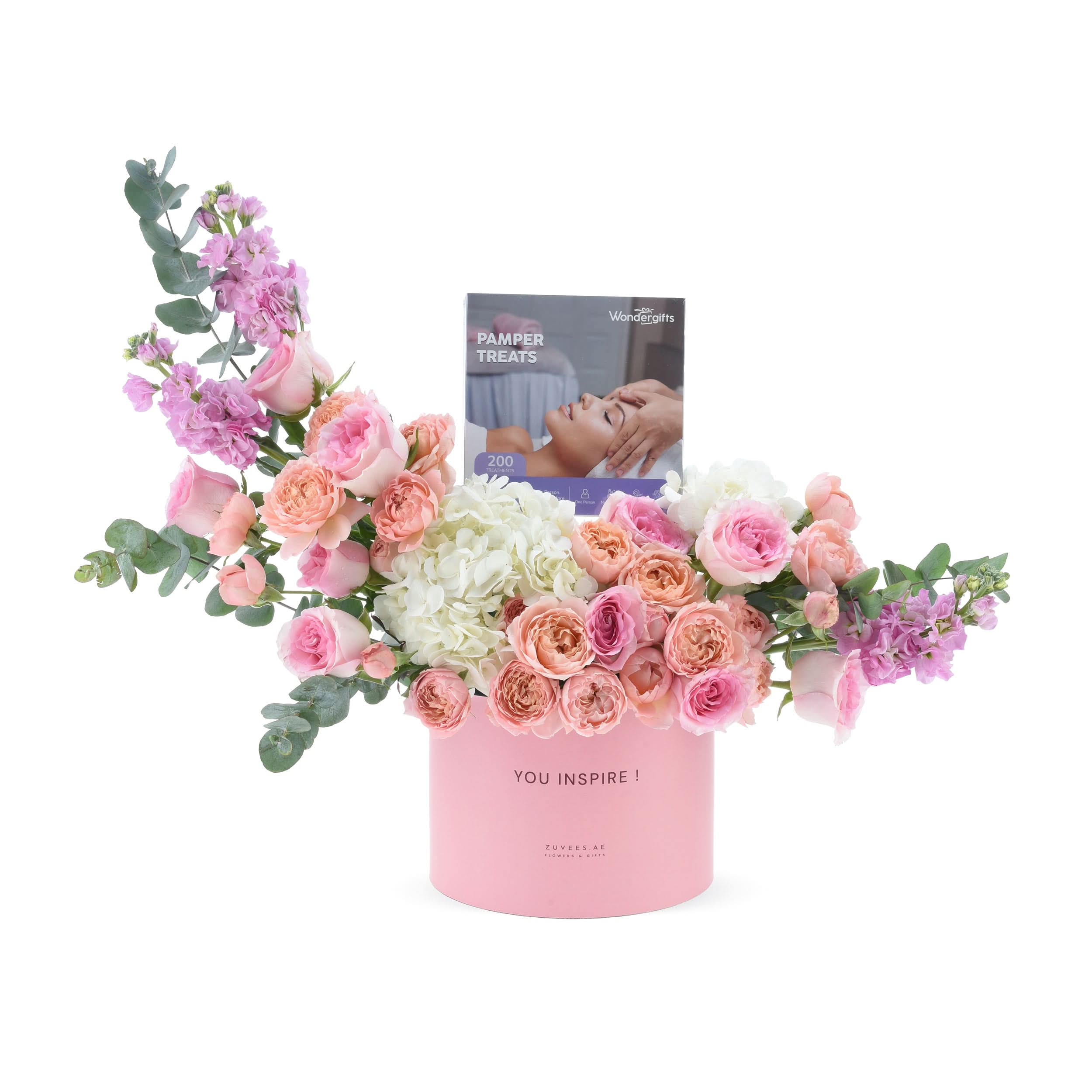 Pink floral arrangement in branded box with pamper treats gift.
