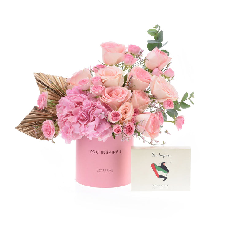 Soft pink roses and hydrangeas in a branded pink box with matching card.