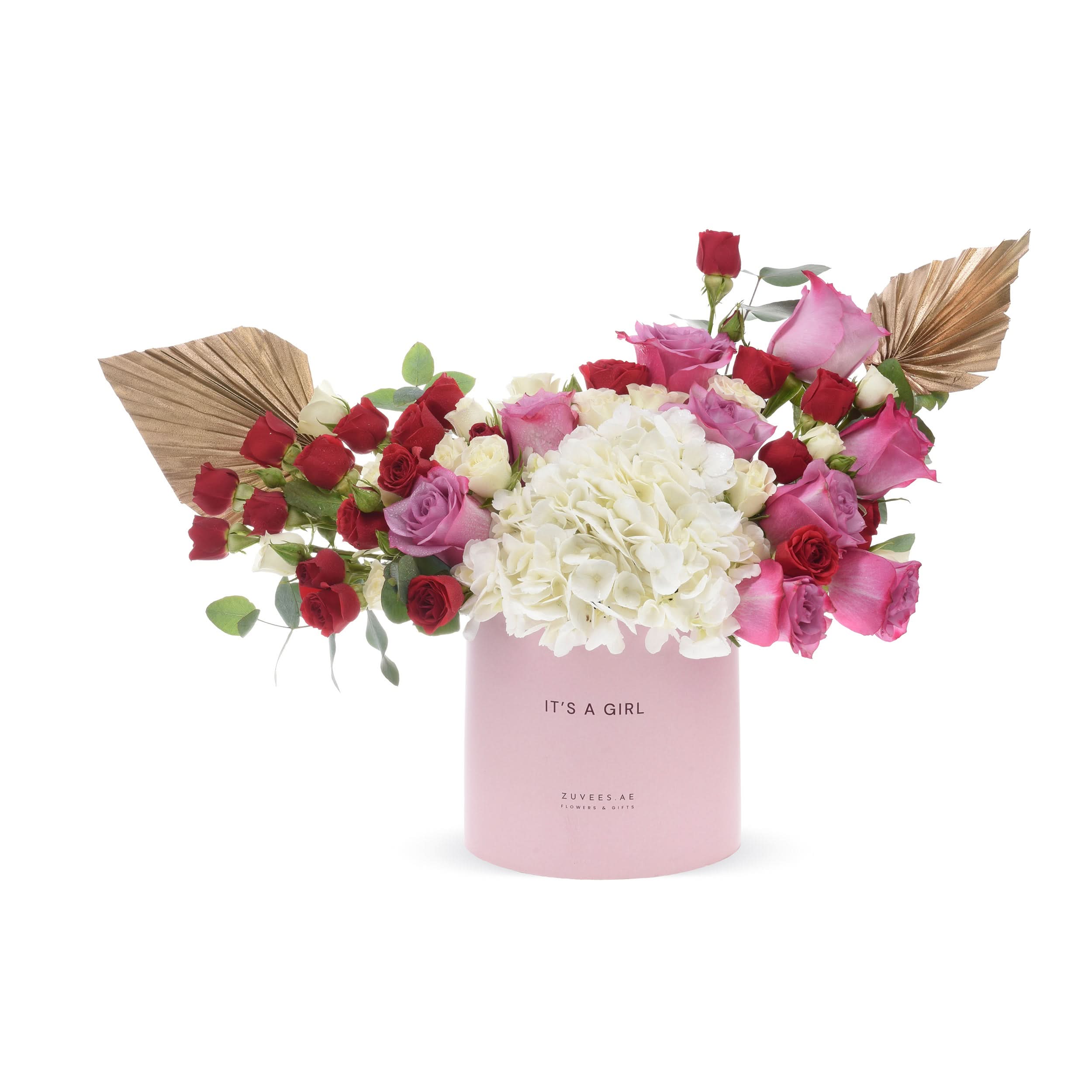 Pink box holds vibrant pink, red, and white roses with hydrangeas and gold leaves.