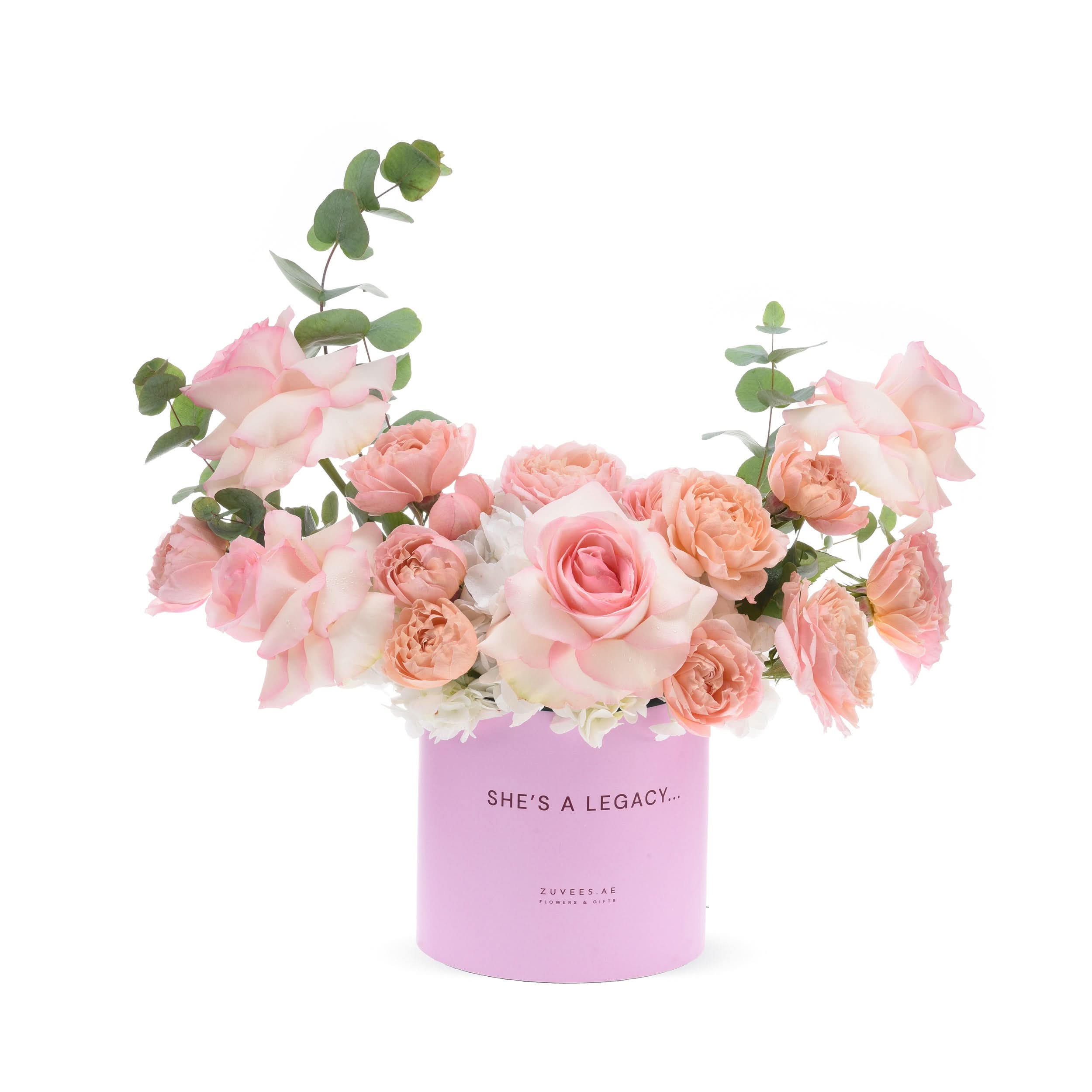Soft pink roses and eucalyptus in pastel pink cylinder vase with "She&