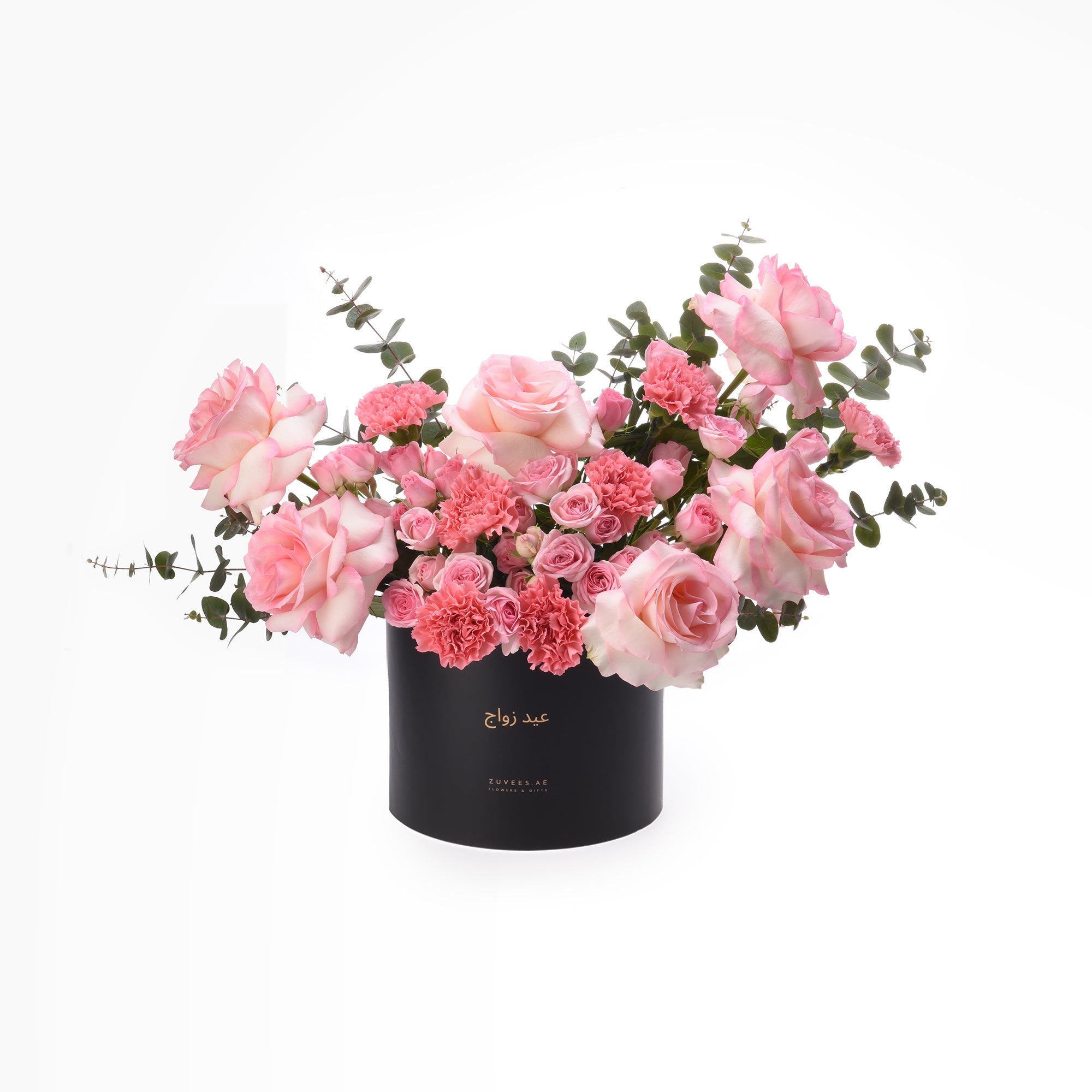 Elegant pink roses and carnations in sleek black box with gold text.