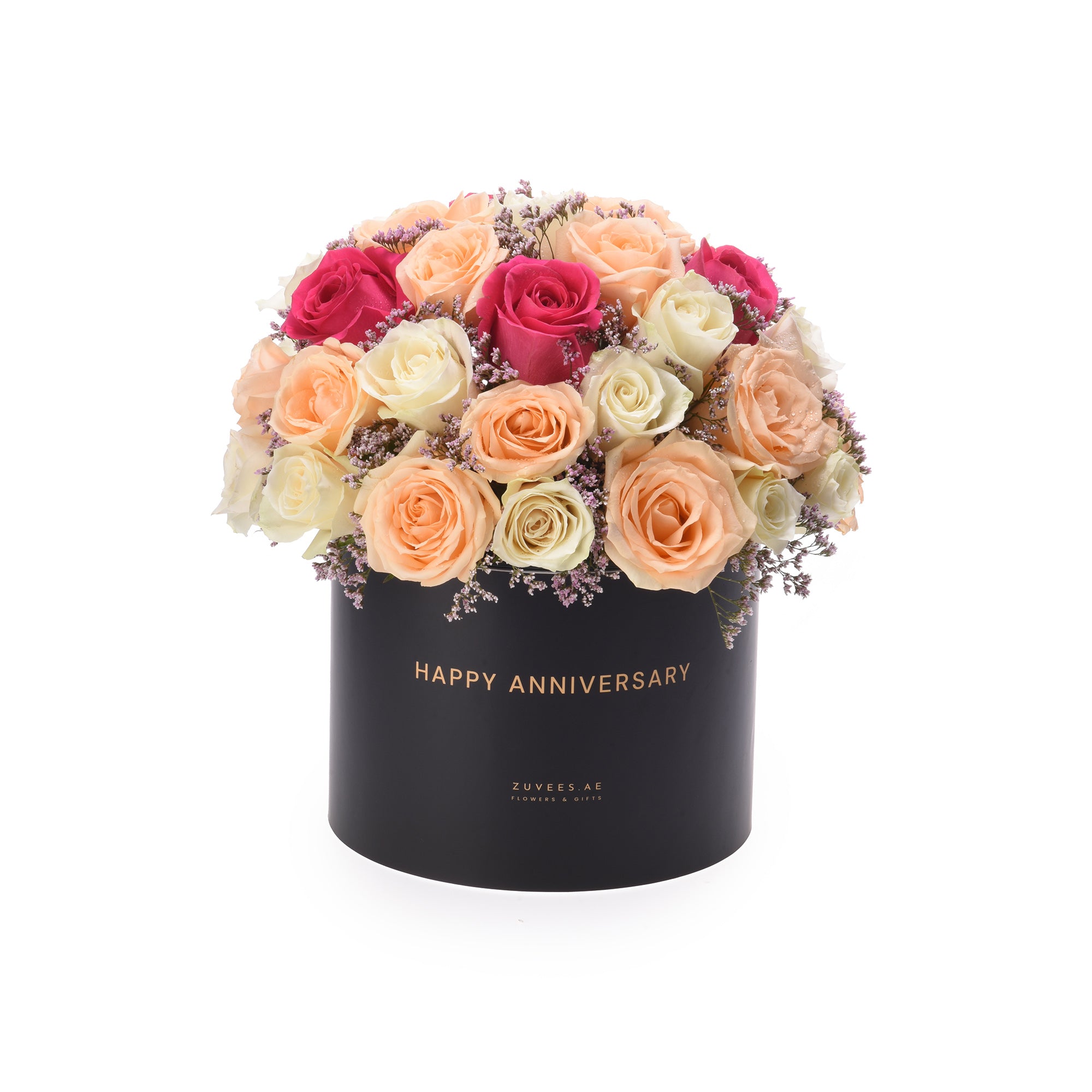 Luxury anniversary roses in black box: peach, cream, magenta blooms with lavender filler, gold "Happy Anniversary" text.