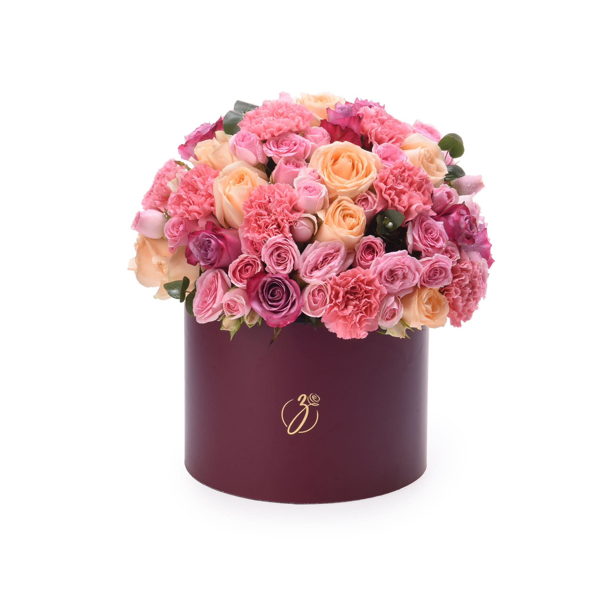Luxurious burgundy hat box overflowing with vibrant pink, peach, and magenta roses and carnations.