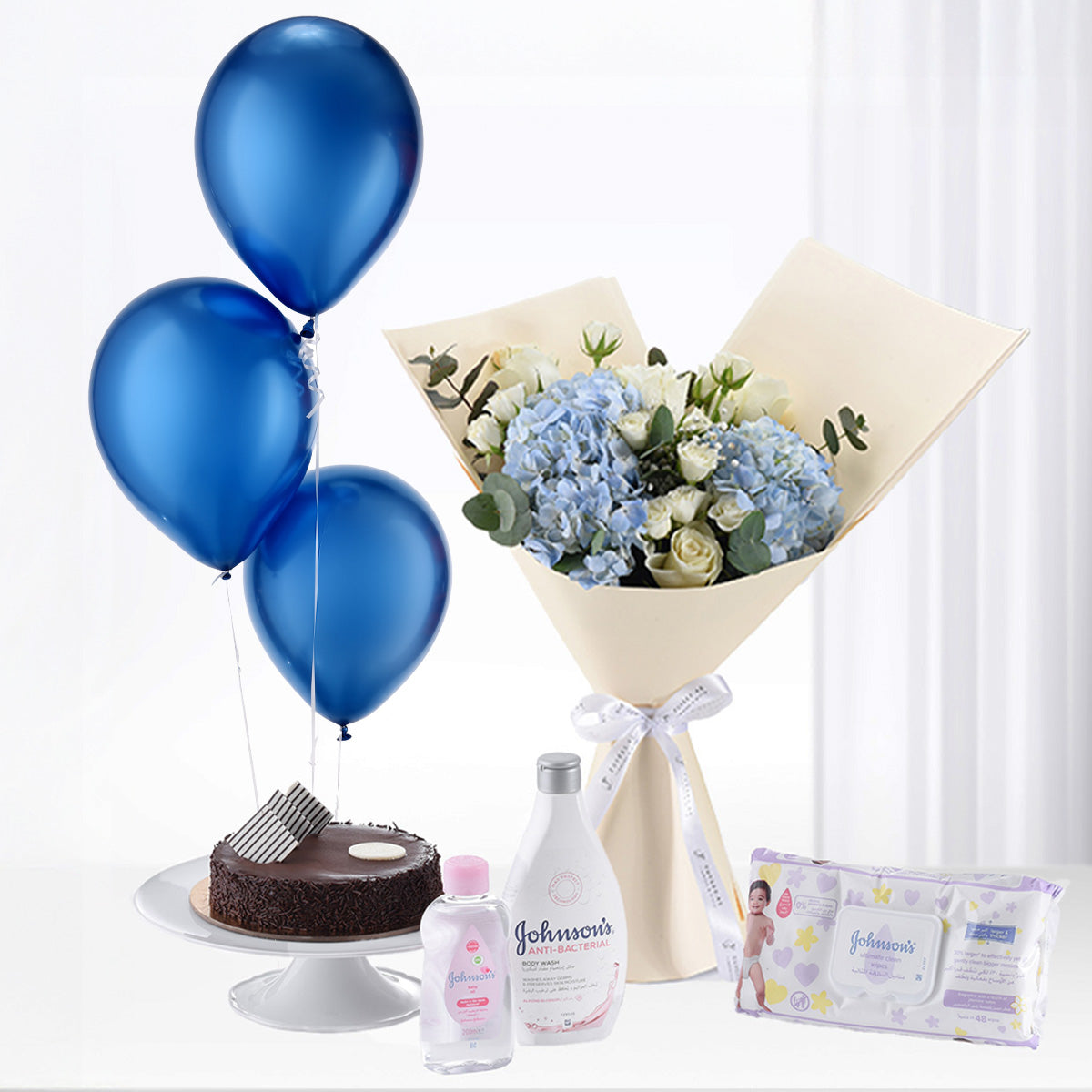 Blue balloons, hydrangea bouquet, baby essentials, chocolate cake, elegant baby shower gift set.