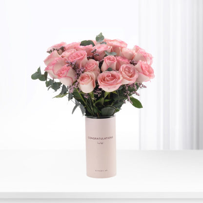 Soft pink roses in minimalist vase, “Congratulations” text, elegant celebration bouquet.