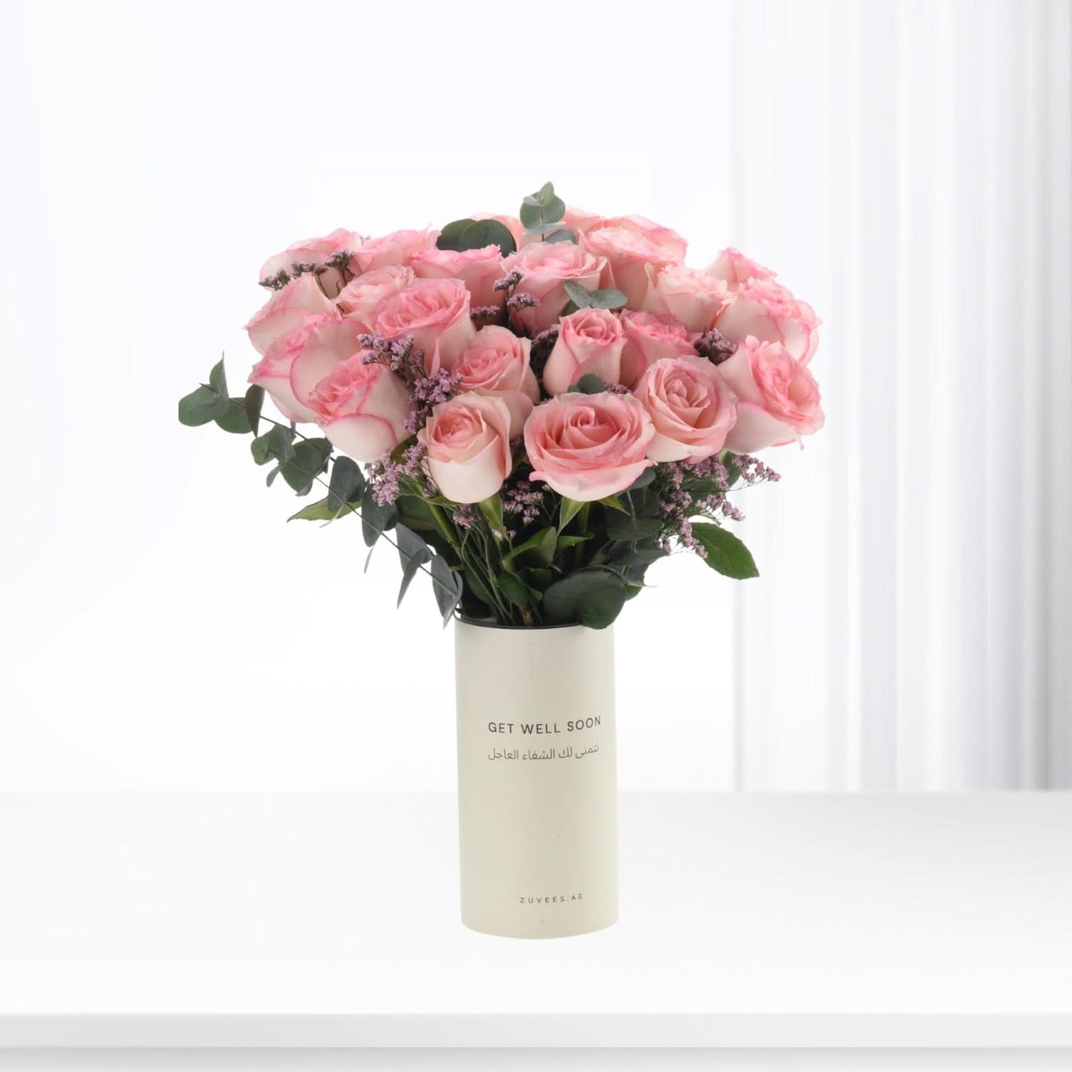 Soft pink roses in minimalist vase with "Get Well Soon" message.