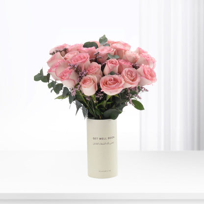 Soft pink roses in minimalist vase with "Get Well Soon" message.