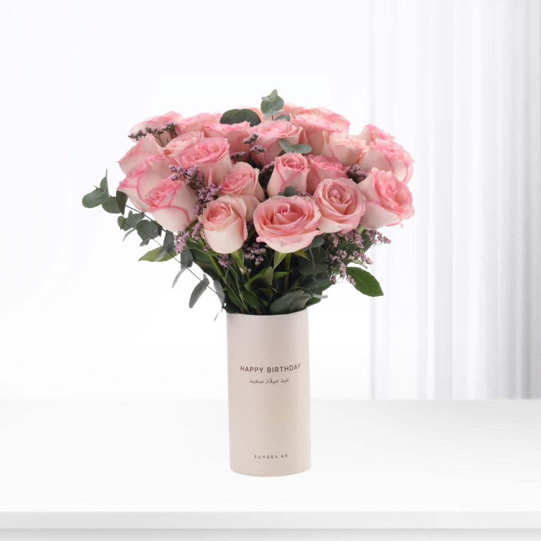 Soft pink roses in minimalist white vase with "Happy Birthday" text.