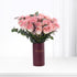 Pink roses in burgundy vase with "Happy Birthday" text, elegant gift arrangement.