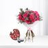 Vibrant pink roses with eucalyptus, wrapped in white paper and pink ribbon, paired with a heart-shaped The Body Shop gift set.