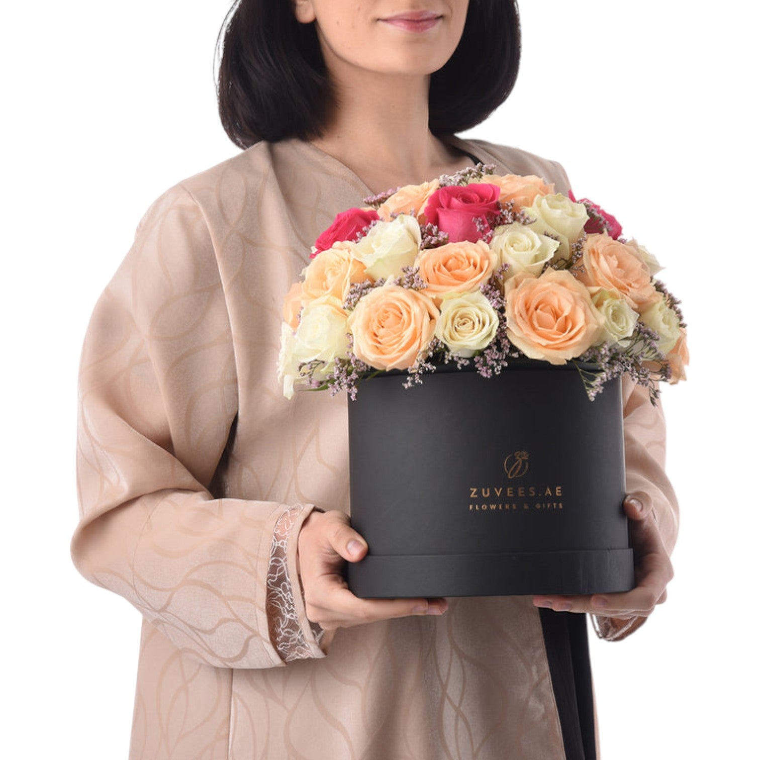 Elegant black box holds vibrant peach, cream, and pink roses with lavender accents.