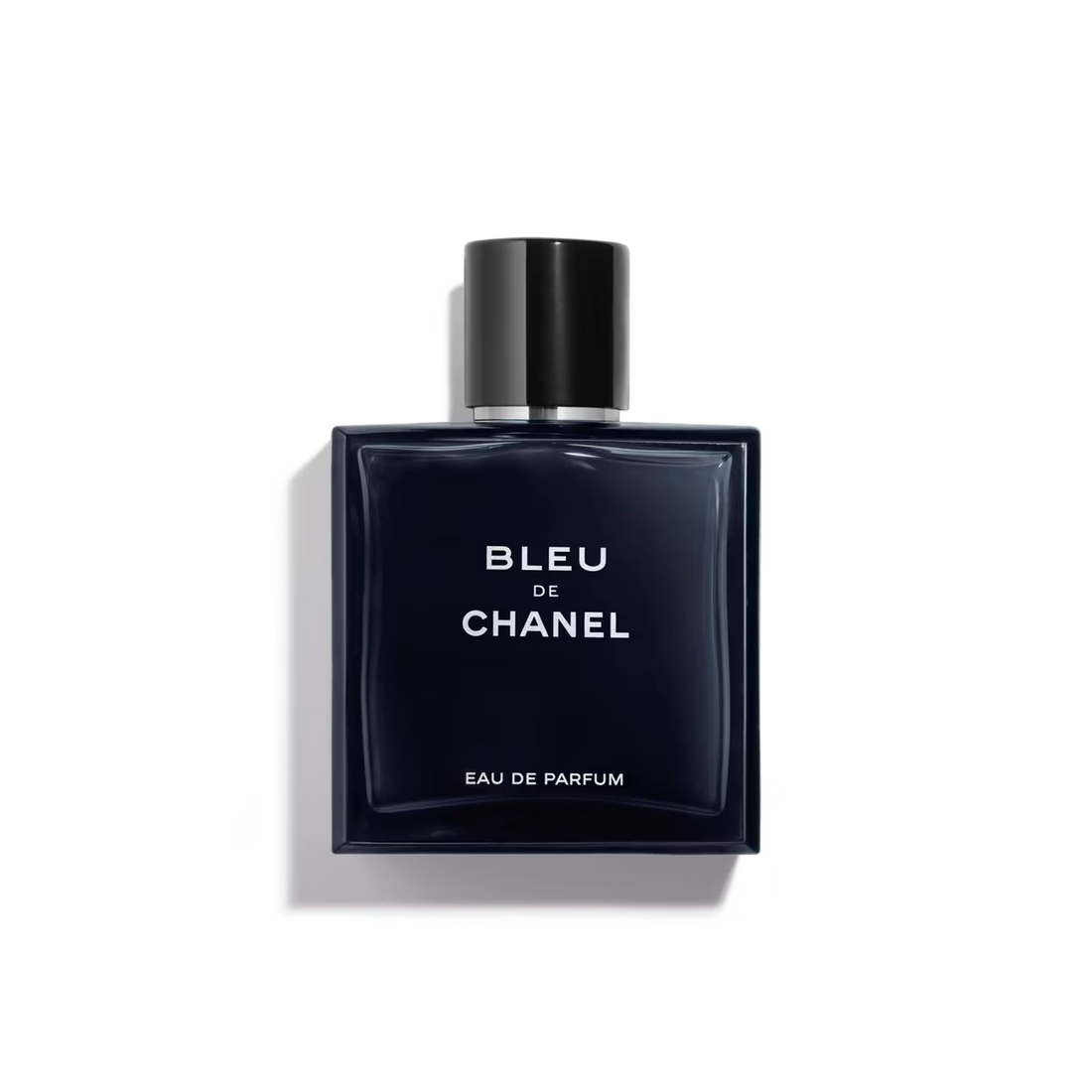 Sleek navy bottle with black cap, bold white "Bleu de Chanel" text.