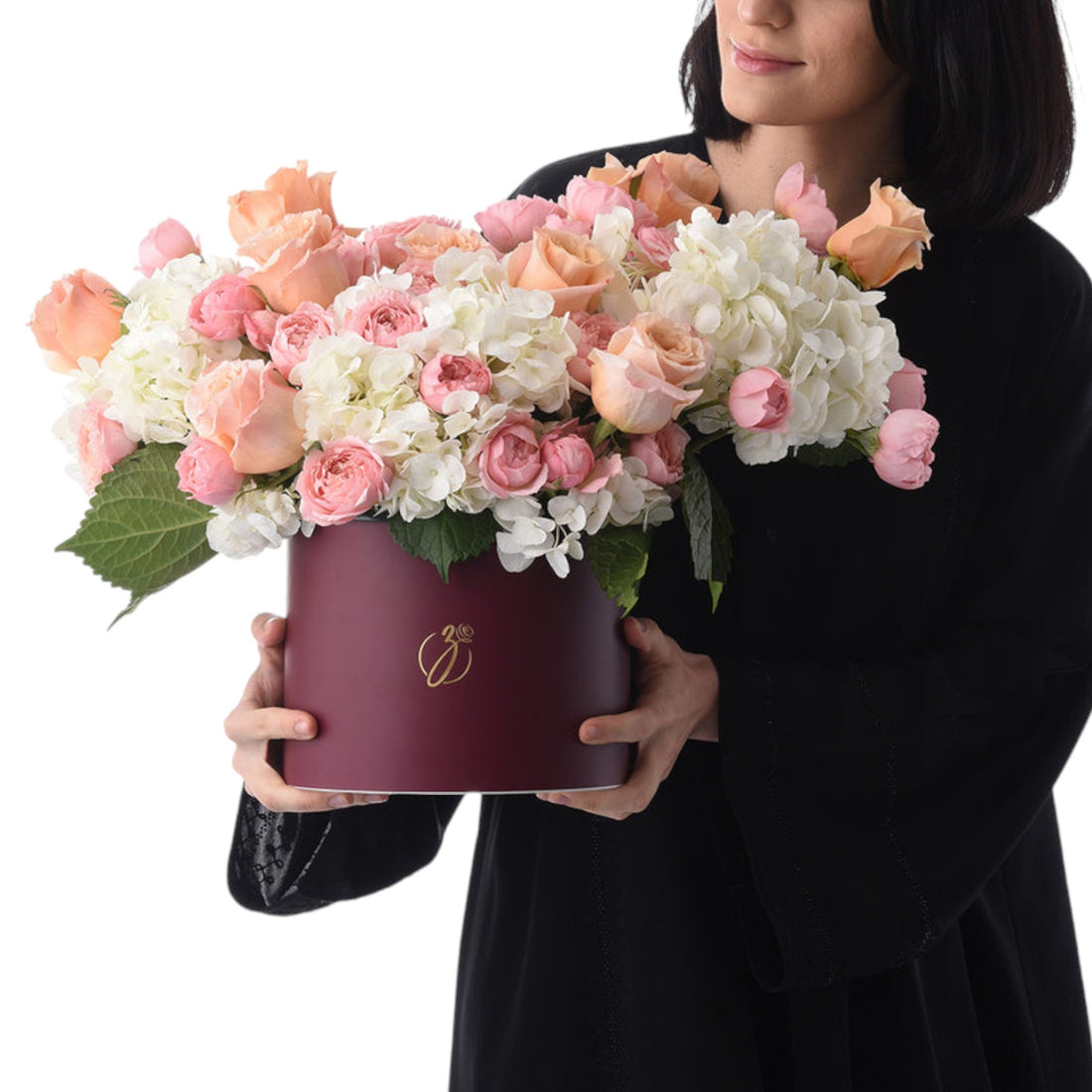 Elegant burgundy hat box filled with soft pink and white roses and hydrangeas.