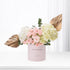 Pink roses and hydrangeas in blush box with gold leaf accents.