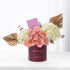 Elegant burgundy box holds blush roses, white hydrangeas, and gold leaf accents for birthday.