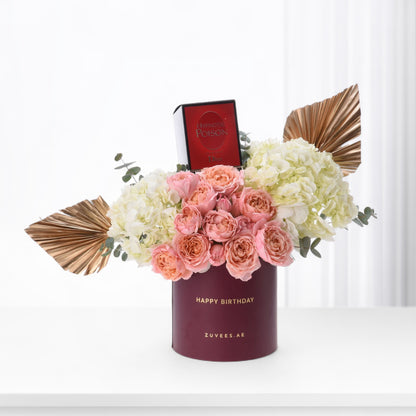 Elegant birthday bouquet in burgundy box with Dior perfume and gold accents.