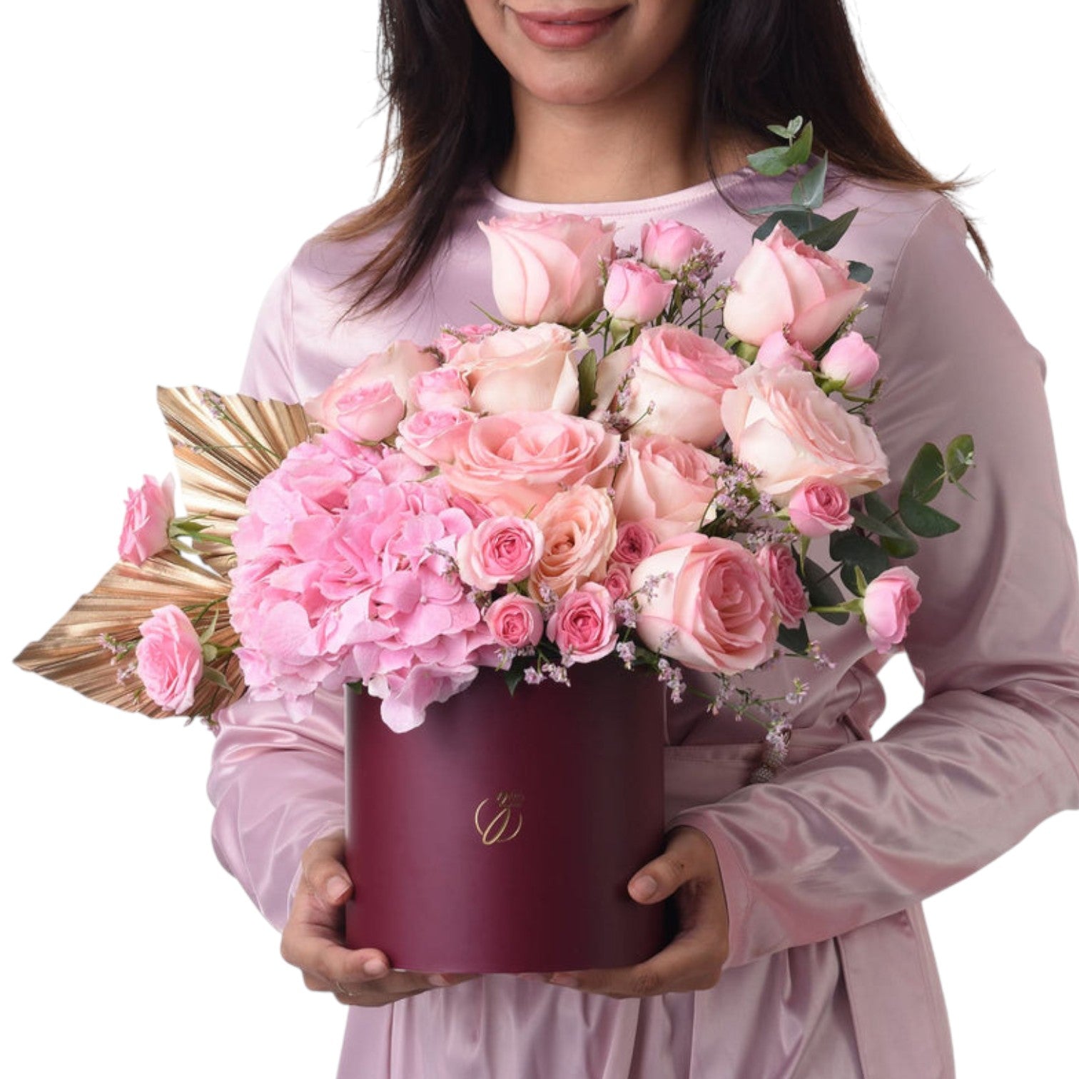 Soft pink roses and hydrangeas in burgundy box with gold leaf accent.