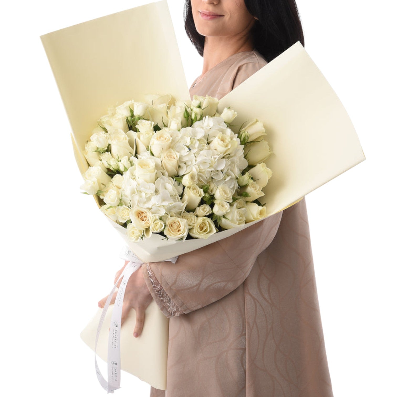 Elegant white rose and hydrangea bouquet wrapped in creamy paper.